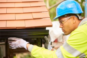 Gutter installation by worker